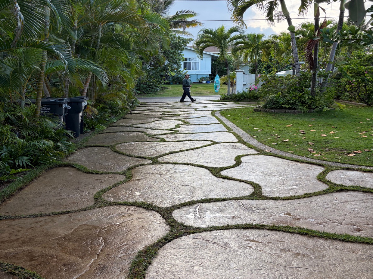 Pressure washing a stone walkway on a North Shore property